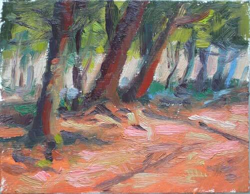 An image of a small painting showing sunlight on a trail leading into the woods. 